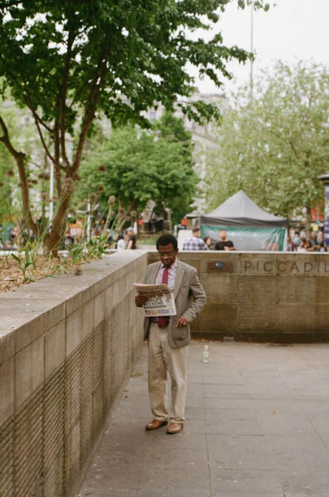 street photography picture of a man reading a newspaper